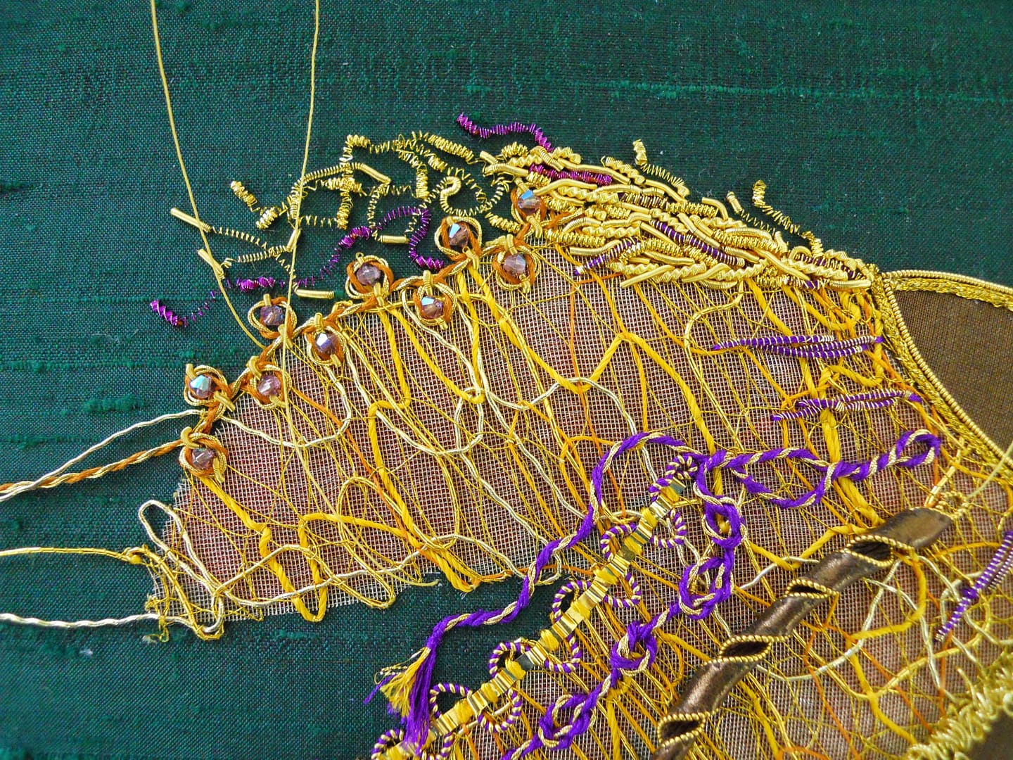 Adding coloured and gold purls to the top of the mane