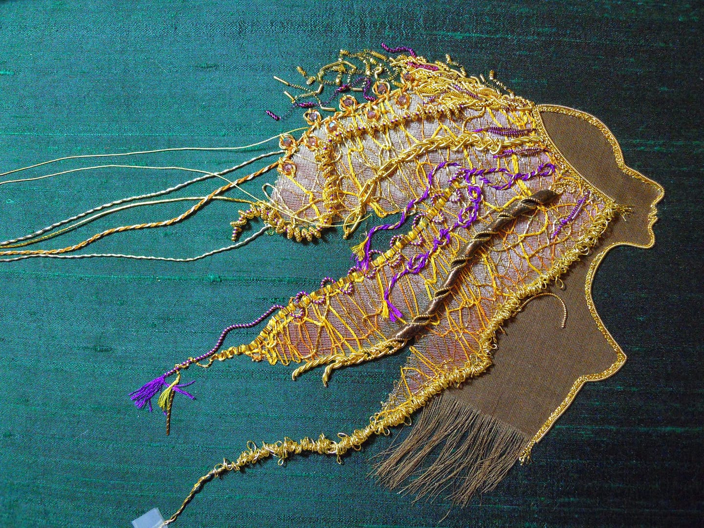 More details in goldthreads are added to Lion Woman's mane