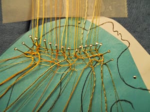 Preparing the bobbin lace ('fond fou') with gold and silk threads