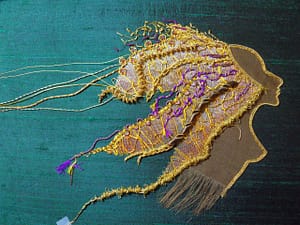 More details in goldthreads are added to Lion Woman's mane