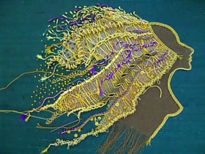 French knots and gold spangles are added to Lion Woman's mane