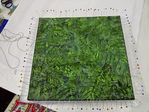 Slip-stiching the green backing fabric on Lion Woman